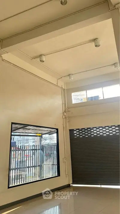 Spacious commercial space with high ceiling and large windows