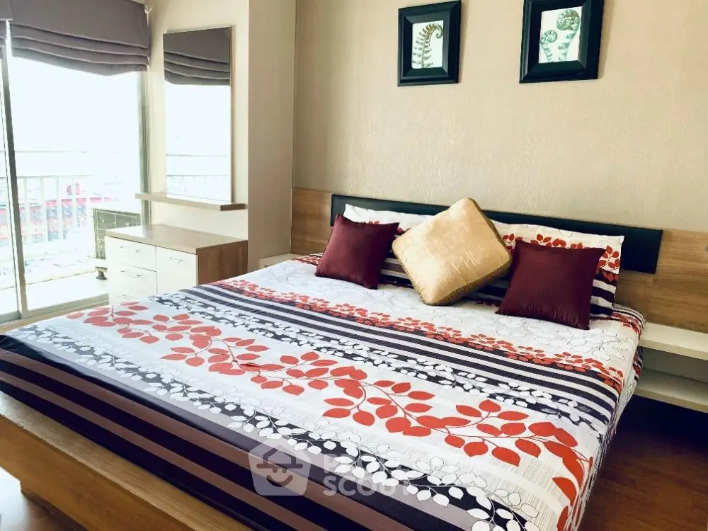 Spacious bedroom with modern decor and large windows for natural light.