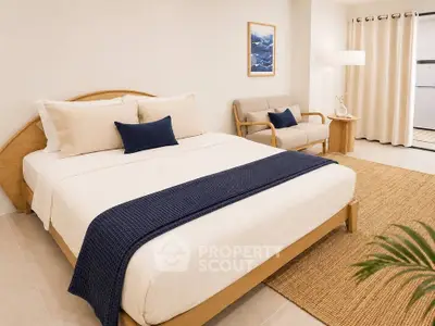 Modern bedroom with stylish decor, cozy seating area, and elegant lighting, perfect for relaxation and comfort.