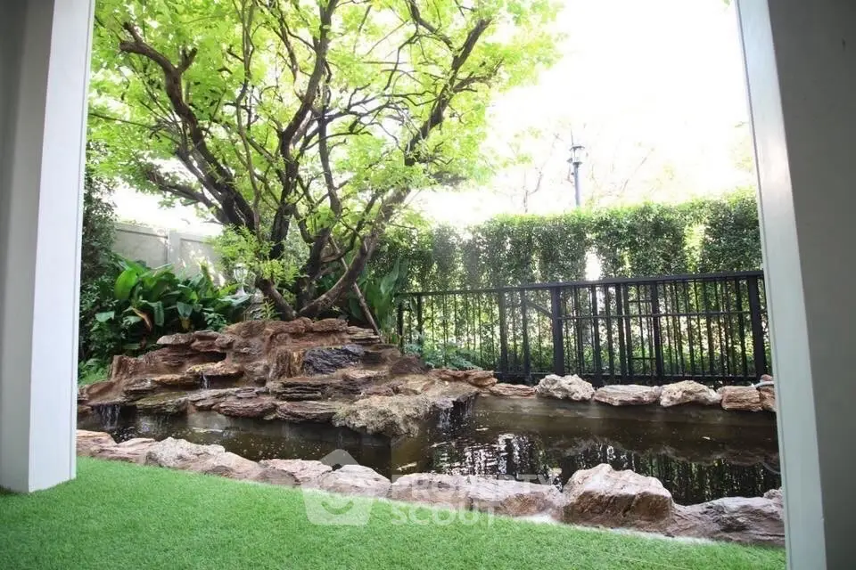 Serene garden view with lush greenery and tranquil pond