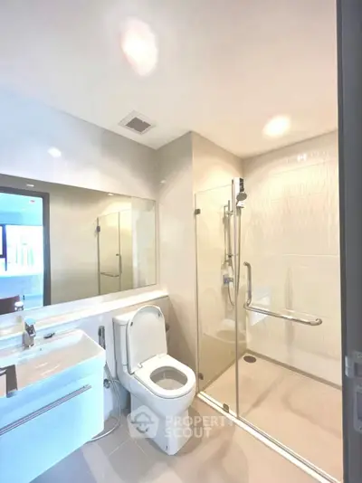 Modern bathroom with glass shower and sleek fixtures