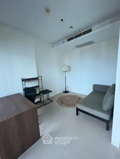 Modern study room with minimalist furniture and ample natural light.