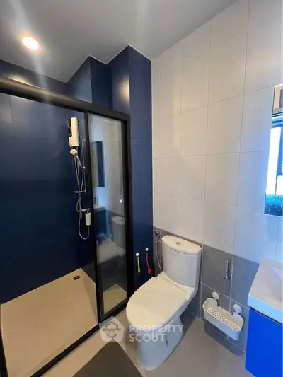 Modern bathroom with sleek shower and contemporary fixtures in stylish apartment.