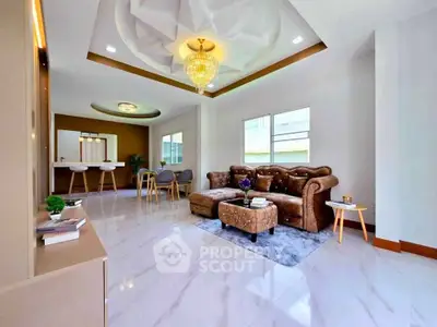 Luxurious living room with elegant chandelier and plush seating in modern home.