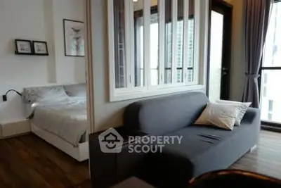 Modern apartment interior with cozy living room and bedroom, featuring stylish decor and natural light.