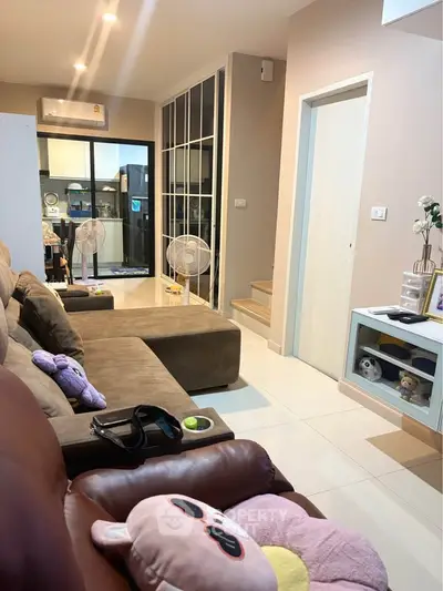 Cozy living room with modern decor and open layout leading to kitchen