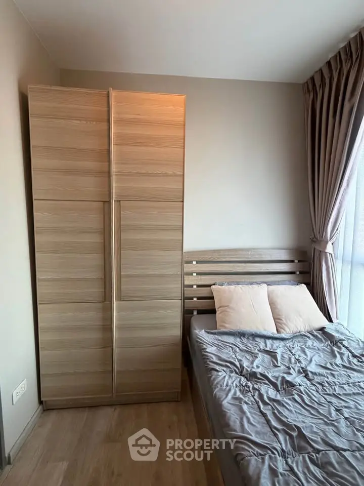 Cozy bedroom with wooden wardrobe and natural light