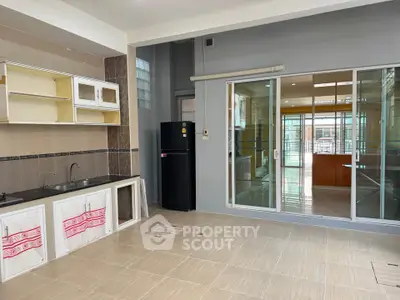 Spacious kitchen with modern appliances and open layout, featuring sleek cabinetry and ample natural light.