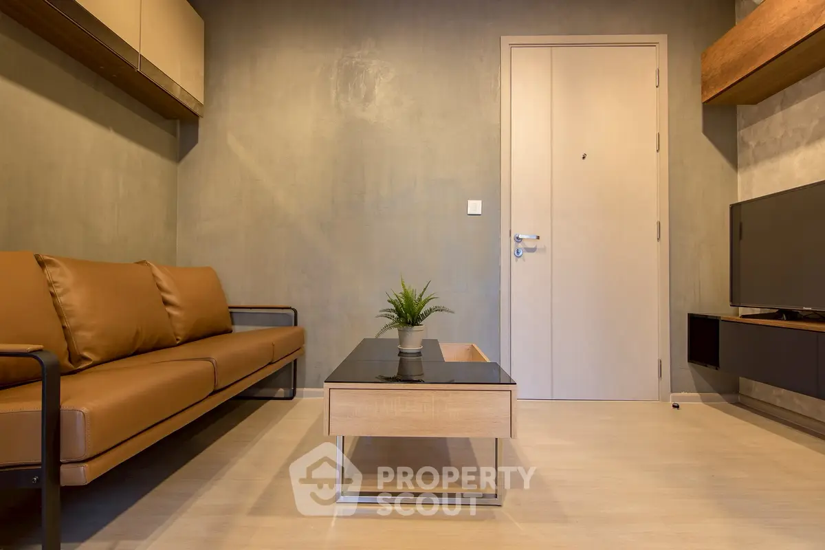 Modern living room with sleek design, featuring a leather sofa and stylish coffee table.