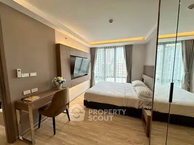 Modern bedroom with large windows and stylish decor in a high-rise apartment.