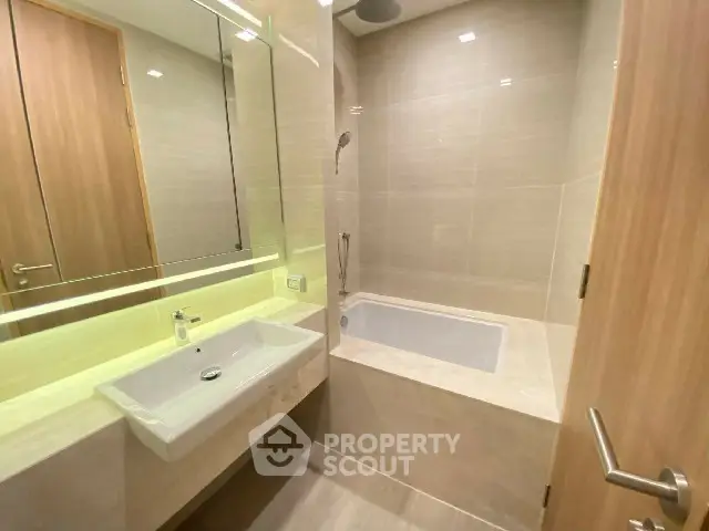 Modern bathroom with built-in bathtub and sleek fixtures
