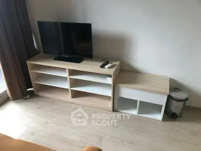 Modern living room with sleek TV stand and minimalist decor, perfect for urban living.