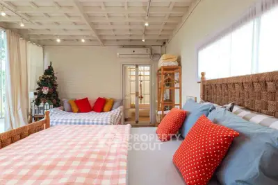 Charming bedroom with cozy beds and festive decor, perfect for a warm holiday retreat.