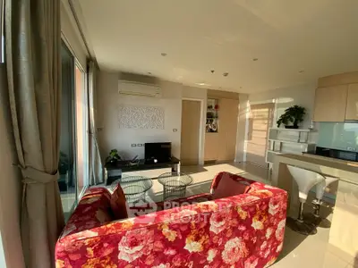 Stylish open-plan living room with floral sofa and modern kitchen