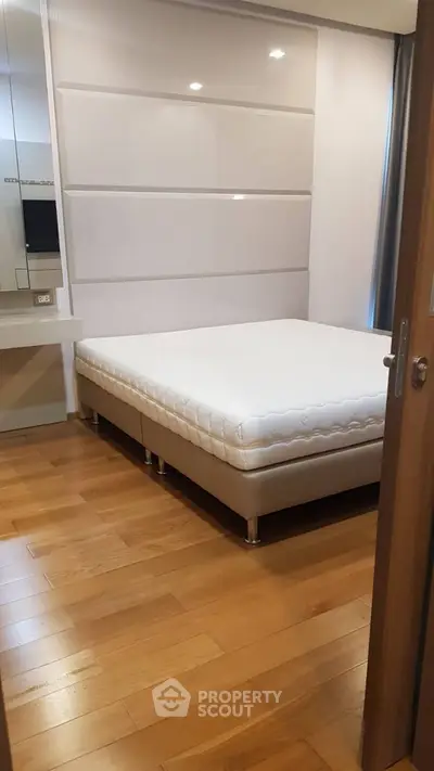 Modern bedroom with sleek design and comfortable bed in a stylish apartment.