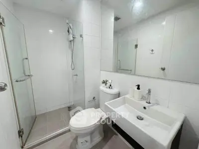 Modern white bathroom with glass shower and sleek fixtures