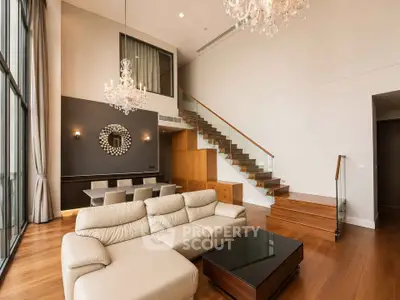 Luxurious modern living room with high ceilings and elegant chandeliers