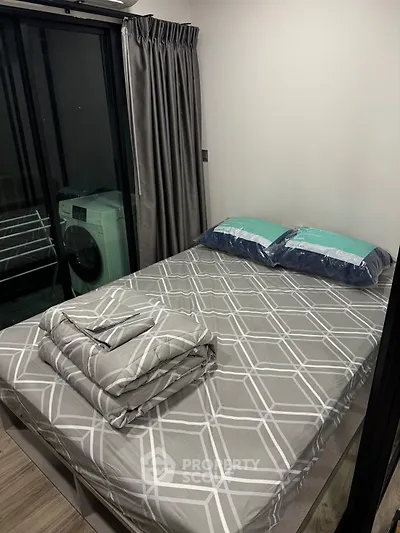 Cozy bedroom with modern decor and washing machine in a compact space.