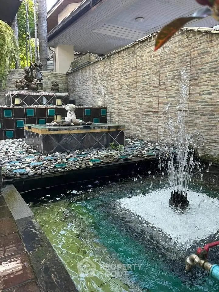 Charming outdoor water feature with decorative fountain and stone accents in a serene garden setting.