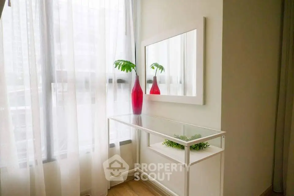 Bright corner with glass table and mirror in modern apartment