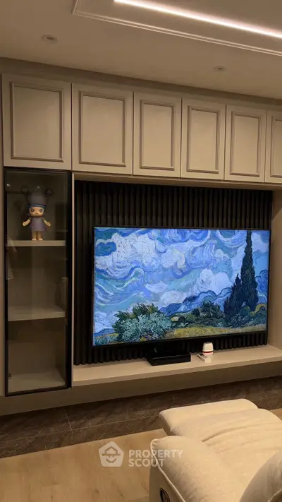 Modern living room with stylish TV setup and elegant cabinetry