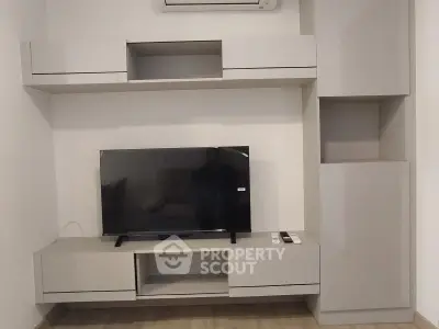 Modern living room with sleek built-in TV unit and air conditioning
