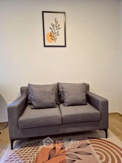 Modern living room with stylish gray sofa and artistic wall decor