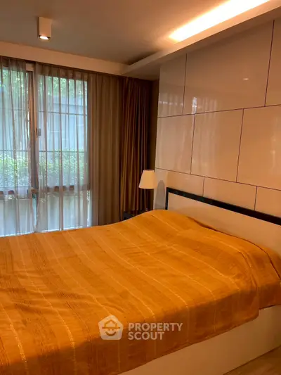 Cozy bedroom with large window and modern decor