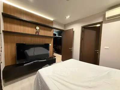 Modern bedroom with sleek TV unit and stylish decor