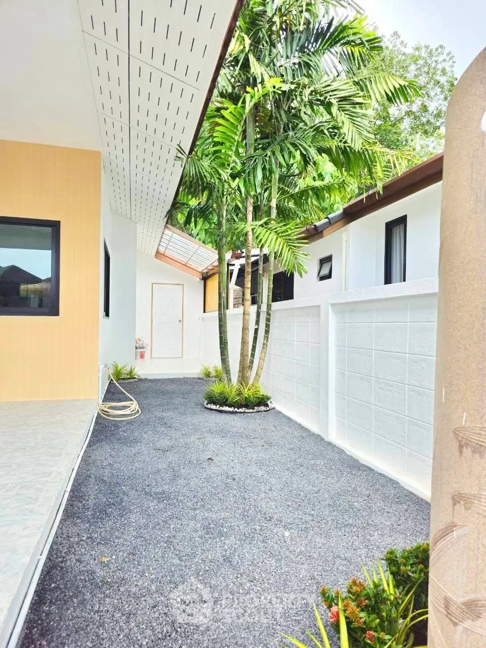 Charming exterior view of a modern home with lush greenery and sleek design.