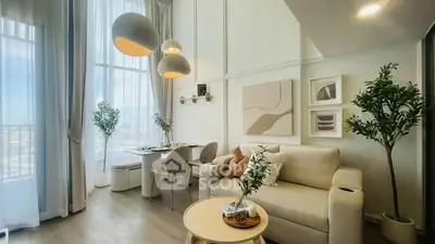 Luxurious modern living room with high ceilings and elegant decor, featuring large windows and stylish furniture.