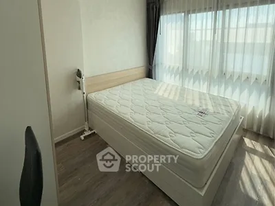 Bright bedroom with large window and modern furnishings