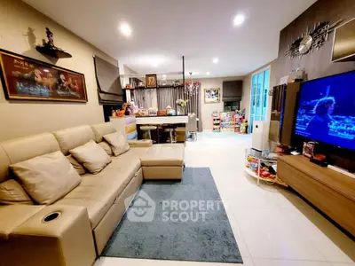 Spacious living room with modern decor and open layout, featuring a comfortable sofa and entertainment area.