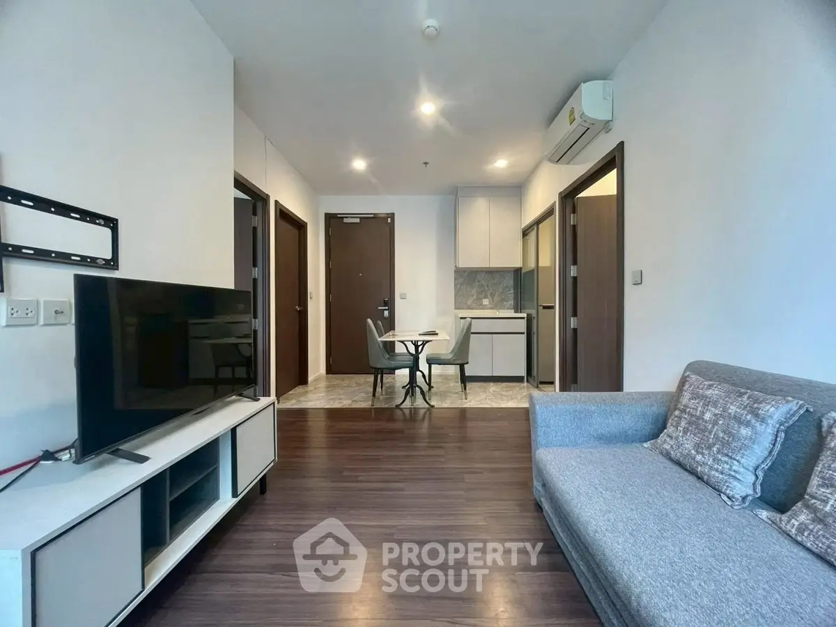 Modern living room with sleek furniture and open kitchen layout