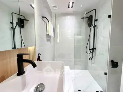 Modern bathroom with sleek fixtures and glass shower enclosure