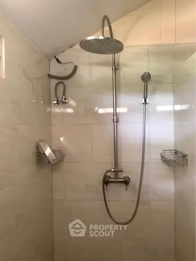 Modern bathroom shower with sleek fixtures and neutral tiles