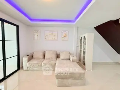 Modern living room with stylish sofa and elegant decor, featuring a unique ceiling light design.