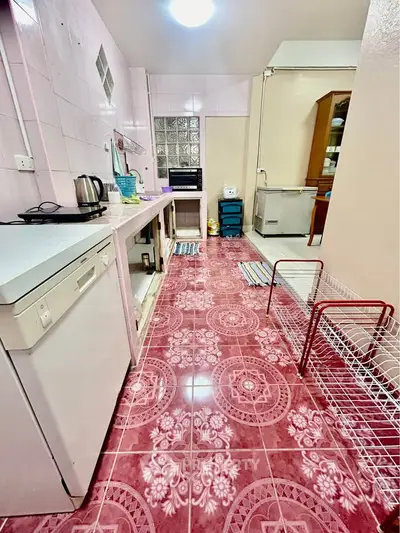 Charming kitchen with unique pink floral tiles and open shelving, perfect for creative culinary adventures.