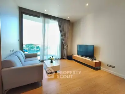 Modern living room with sleek furniture and large balcony view