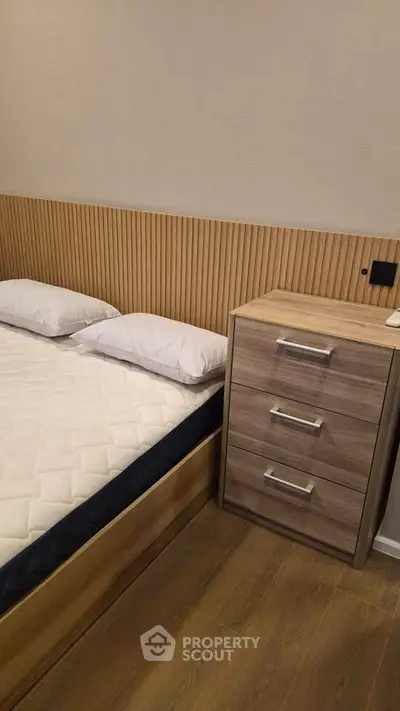 Modern bedroom with stylish wooden headboard and sleek bedside table