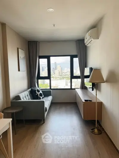 Modern living room with city view, featuring sleek furniture and large windows for natural light.