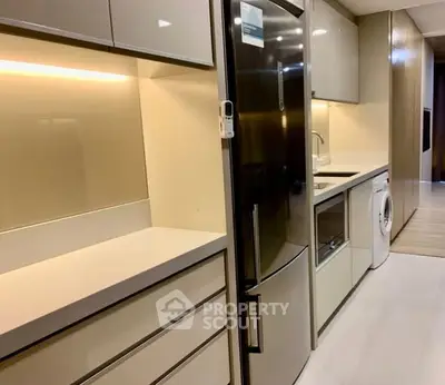 Modern kitchen with sleek cabinetry and integrated appliances
