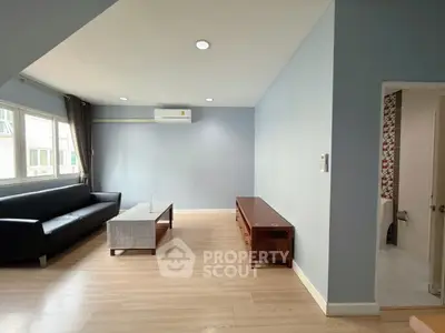 Spacious living room with modern furnishings and natural light