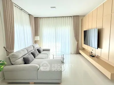 Spacious modern living room with elegant sofa and large TV