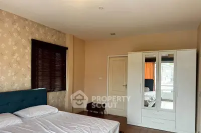 Spacious bedroom with modern wardrobe and stylish decor in a cozy apartment.