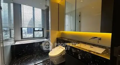 Luxurious modern bathroom with city view, featuring sleek design and high-end fixtures.