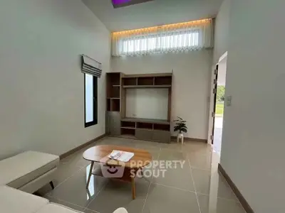 Modern living room with sleek furniture and natural light, perfect for relaxation and entertainment.