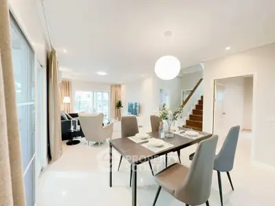 Spacious modern living and dining area with elegant decor and natural light.