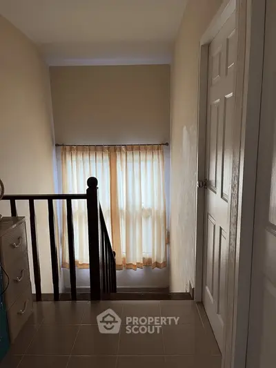 Cozy hallway with natural light and elegant curtains