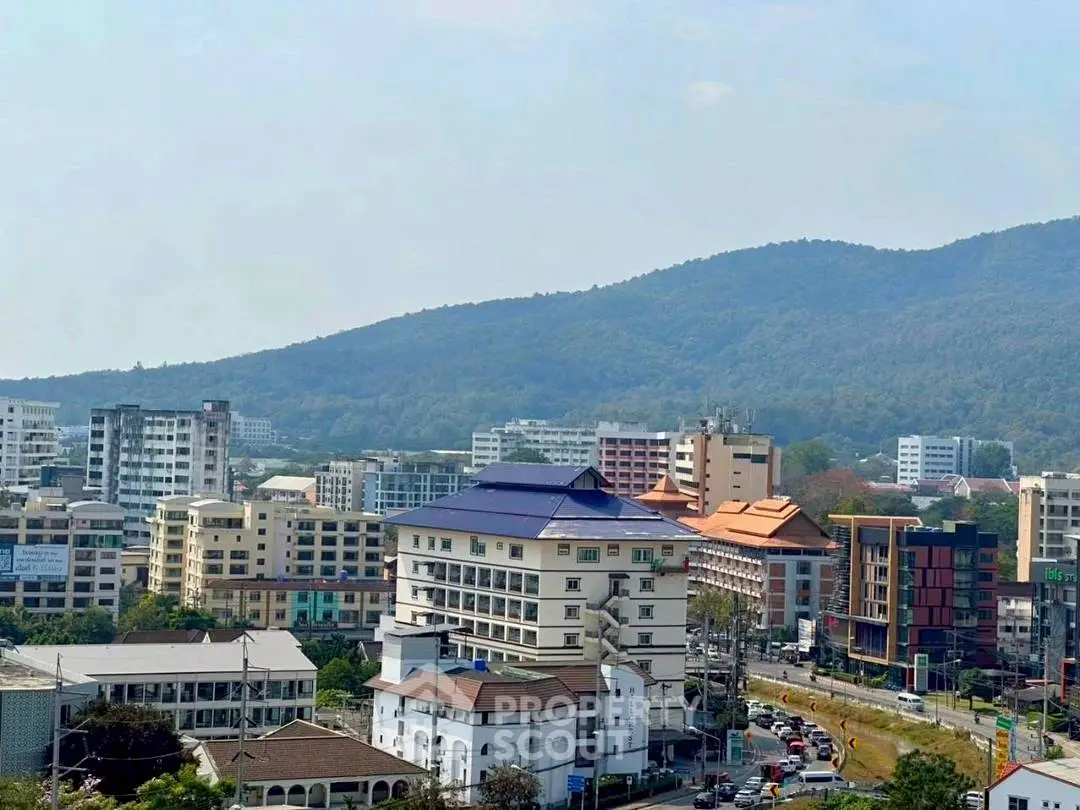 Scenic cityscape with mountain backdrop and diverse architecture.